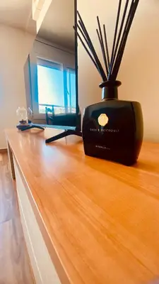 a black vase sitting on top of a wooden table at LEB Apartments in Pineda de Mar