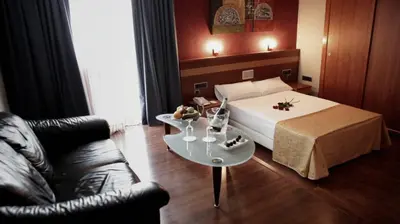 a hotel room with a bed and a table at Hotel Iris in Granollers