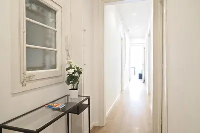 a hallway with a glass table and a window at Suites4days Sagrada Familia Apartment in Barcelona