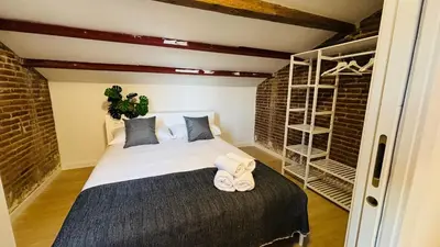 a bedroom with a bed with towels on it at Céntrico ático by Prestigi in Terrassa