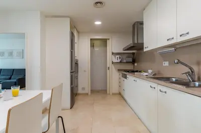 a kitchen with white cabinets and a counter top at 4168 - AB Josep Pla- Diagonal Mar in Barcelona