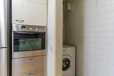 a kitchen with a washer and dryer next to a washing machine at 4168 - AB Josep Pla- Diagonal Mar in Barcelona