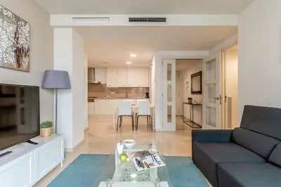 a living room with a couch and a table at 4168 - AB Josep Pla- Diagonal Mar in Barcelona