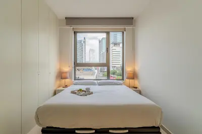 a bedroom with a large bed with a window at 4168 - AB Josep Pla- Diagonal Mar in Barcelona