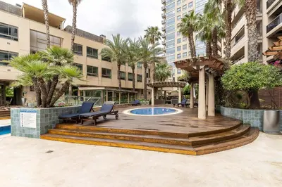 a deck with benches and a pool in a building at 4168 - AB Josep Pla- Diagonal Mar in Barcelona