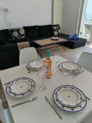 a table with plates and wine glasses on it at Port Alegre Mar in Sitges