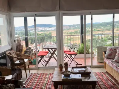 a living room with a view of a balcony at Sea Views Penthouse in Sitges