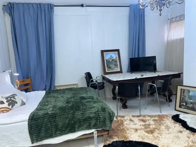 a room with a bed and a table and chairs at Tessasapartments Sabadell 4 in Sabadell