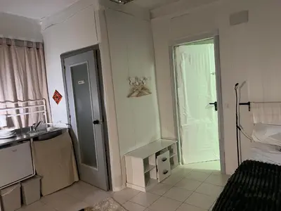 a bathroom with a sink and a door to a bedroom at Tessasapartments Sabadell 4 in Sabadell