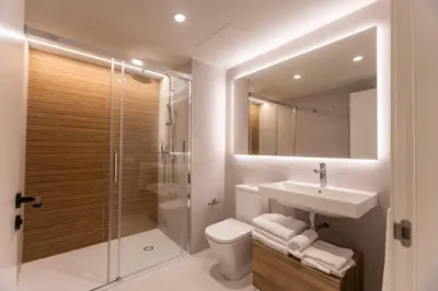 a bathroom with a toilet and a sink and a shower at Fels Apartments in Castelldefels