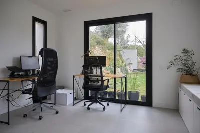 an office with two desks and two chairs and a window at Villa Sitges Casa Selva 7 minutos de Sitges en coche Diseño Comodidad Nueva Ideal para Vacaciones in Sant Pere de Ribes