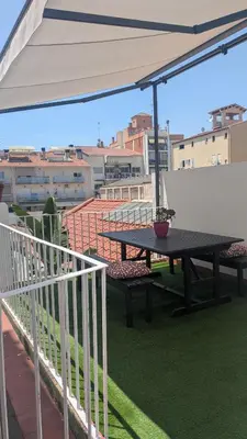 a kitchen with a white refrigerator and a sink at Centric apartment 100m from the beach in Mataró
