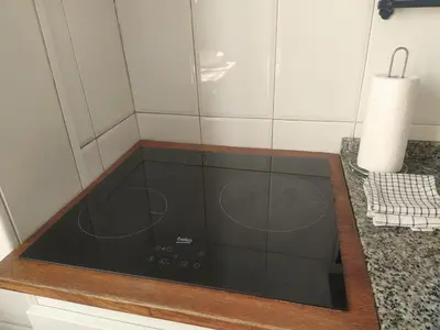 a dining room with a table and a tv on the wall at Centric apartment 100m from the beach in Mataró
