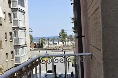 a view of the beach from a balcony of a building at Centric apartment 100m from the beach in Mataró
