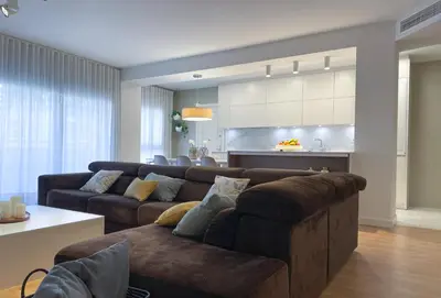 a living room with a couch and a kitchen at Apartment Monet in Vilanova i la Geltrú