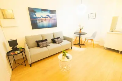 a living room with a couch and a table at rentBCN Paseo de Gracia Apartments in Barcelona