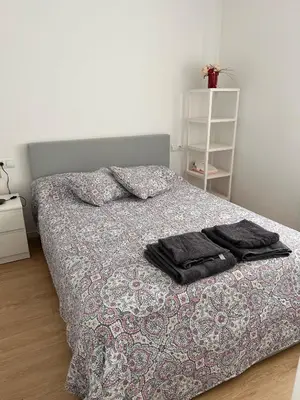 a bed with two towels on it in a bedroom at Apartment by the sea in Cubelles in Cubelles
