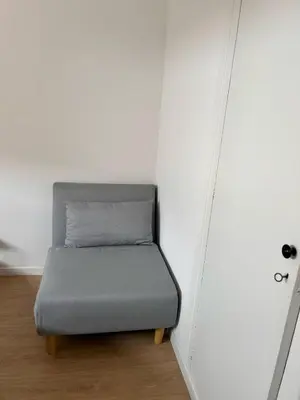 a small bed in a corner of a room at Apartment by the sea in Cubelles in Cubelles