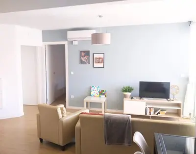 a living room with a couch and a tv at Apartment by the sea in Cubelles in Cubelles