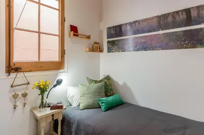 a small bedroom with a bed and a window at 2088 - AB Sagrada Familia in Barcelona