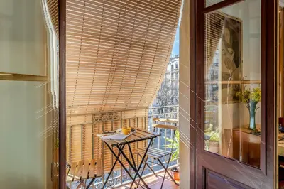 a balcony with a table and a view of the eiffel tower at 2088 - AB Sagrada Familia in Barcelona