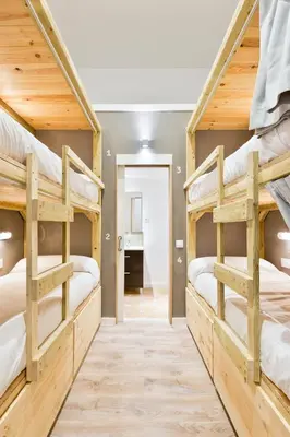 a room with three bunk beds in a house at Ant Hostel Barcelona in Barcelona