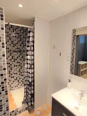 a bathroom with a sink and a shower curtain at Ant Hostel Barcelona in Barcelona