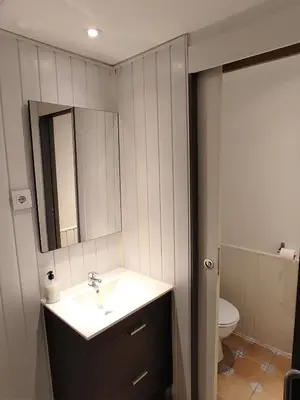 a bathroom with a sink and a mirror and a toilet at Ant Hostel Barcelona in Barcelona