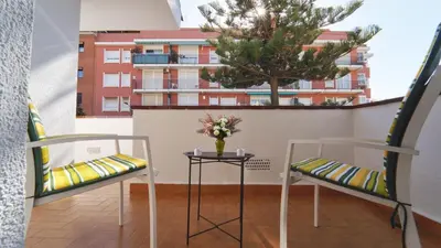 two chairs and a table on a balcony with a tree at SeaHomes Vacations - Villa Chill & Pool 200m Beach in Pineda de Mar