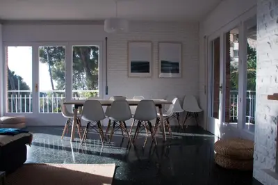 a dining room with a table and chairs at Apartamentos Villa Valle in Castelldefels