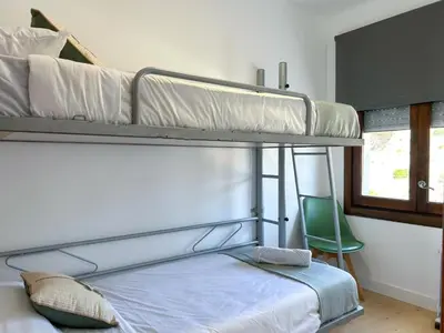a bedroom with a bed and a dresser at PalmBreeze in Vilanova i la Geltrú