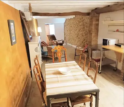a kitchen and dining room with a table and chairs at Old Town Montserrat in Collbató