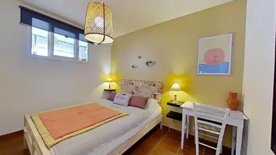 a bedroom with a bed and a desk in it at For Sea Lovers in Cubelles