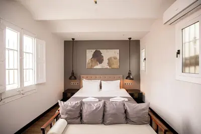 a bedroom with a bed and a couch at luminous top floor apartment with terrace in Barcelona
