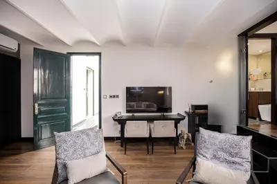 a living room with a table and a television at luminous top floor apartment with terrace in Barcelona