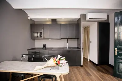 a kitchen with a table with flowers on it at luminous top floor apartment with terrace in Barcelona