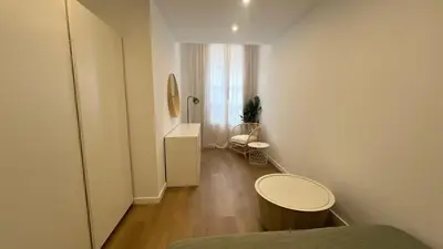 a small white room with a table and a chair at Piso Centro Badalona in Badalona