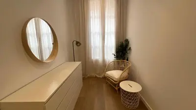 a room with a mirror and a chair and a table at Piso Centro Badalona in Badalona