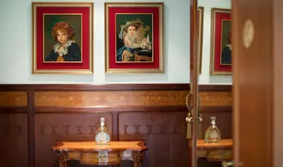 a room with paintings of women on the wall at Hotel Boutique Edelweiss La Garriga in La Garriga