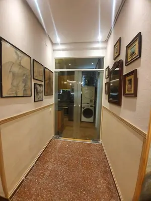 a hallway with pictures on the walls of a building at Barcelona RAVAL Y ROQUETES in Hospitalet de Llobregat