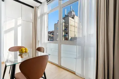 a glass table and chairs in a room with a window at Sants Station Base 500Mb Wi-Fi AC in Barcelona