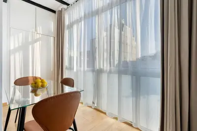a glass table and chairs in a room with a large window at Sants Station Base 500Mb Wi-Fi AC in Barcelona