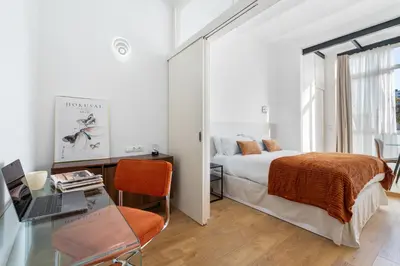 a bedroom with a bed and a desk with a laptop at Sants Station Base 500Mb Wi-Fi AC in Barcelona