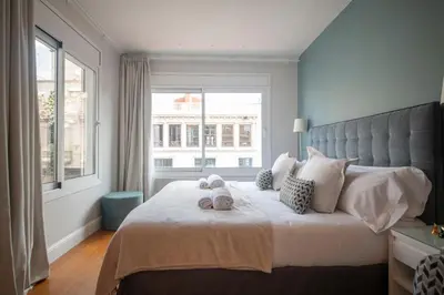 a bedroom with a large bed with two stuffed animals on it at Ático dúplex con cinco dormitorios in Barcelona