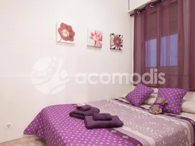 a bedroom with a purple bed with purple sheets at Ideal Location in L'Eixample! - Walk to Sagrada Familia and Barcelona Old Town! in Barcelona
