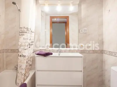 a bathroom with a white sink and a mirror at Ideal Location in L'Eixample! - Walk to Sagrada Familia and Barcelona Old Town! in Barcelona