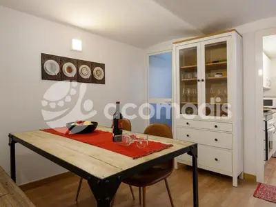a dining room with a table with wine glasses on it at Great and nice 1 bedroom apartment close to Camp Nou in Barcelona