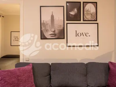 a living room with a couch and pictures on the wall at Vigatans in Barcelona