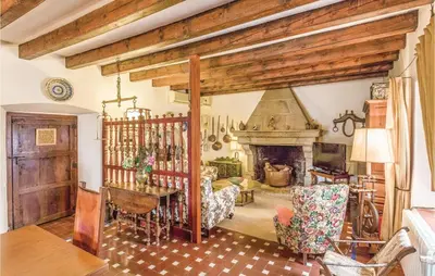 a living room with a table and a fireplace at Nice Home In Arenys De Munt in Arenys de Munt
