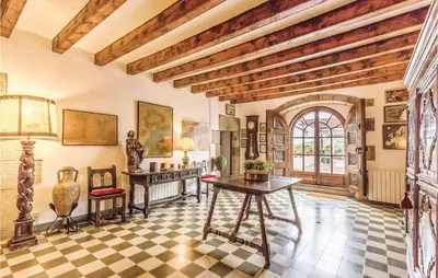 a living room with a table and a checkerboard floor at Nice Home In Arenys De Munt in Arenys de Munt
